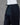 Black pants on a mannequin against a gray background