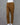 Brown cotton pants on a mannequin against a gray background