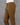 Khaki brown cotton pants on a mannequin against a gray background