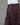 Deep brown pants on a mannequin against a gray background
