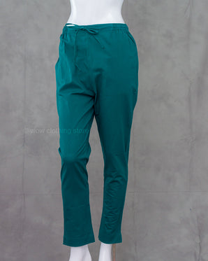 Deep green pants on a mannequin against a gray background