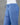 Blue pants with drawstring waist on a gray background