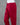 Red cotton pants on a mannequin against a gray background