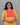 Woman wearing a yellow kurta with a red and orange neck work against a gray background