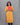 Woman wearing a yellow kurti with black pant against a gray background