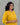 A women wearing a plain yellow kurti with mirror work and plain bottom