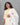 Woman wearing a light yellow kurti with a white printed dupatta against a gray background