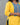 Yellow kurta with blue embroidered details on a gray background