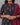 A women wearing printed black cotton kurti with plain bottom and printed maroon color dupatta on a grey background