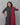 A women wearing printed black cotton kurti with plain bottom and printed maroon color dupatta on a grey background