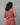 A women wearing a  kalamkari printed pure cotton collored kurti on a grey background