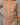Woman wearing a brown shirt with colorful vertical stripes on a gray background