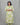 Woman wearing a green and white patterned kurti set against a gray background