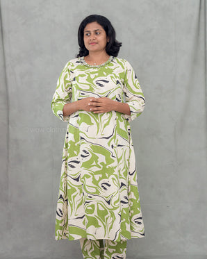 Woman wearing a green and white patterned kurti set against a gray background