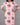 Woman wearing a pink dress with red floral patterns on a gray background