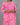 Person wearing a pink floral kurti against a gray background