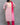 Woman wearing a pink and white top with a matching dupatta against a gray background