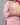 Woman wearing a pink and white floral patterned outfit against a gray background