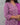Woman wearing a purple floral patterned outfit against a gray background
