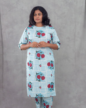 Woman wearing a patterned kurta with a plain background