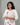 A women wearing a printed white color cotton kurti on a grey background