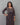 A lady wearing a printed black cotton kurti on a grey background
