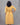 Woman wearing a yellow dress against a gray background
