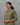 Woman wearing a green and purple striped kurti against a gray background