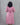 Person wearing a pink dress against a gray background