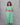 Woman wearing a green dress against a gray background