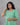Woman wearing a green dress against a gray background
