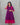 Woman wearing a purple and pink maternity dress against a gray background