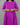 Purple dress with white patterns worn by a person on a gray background